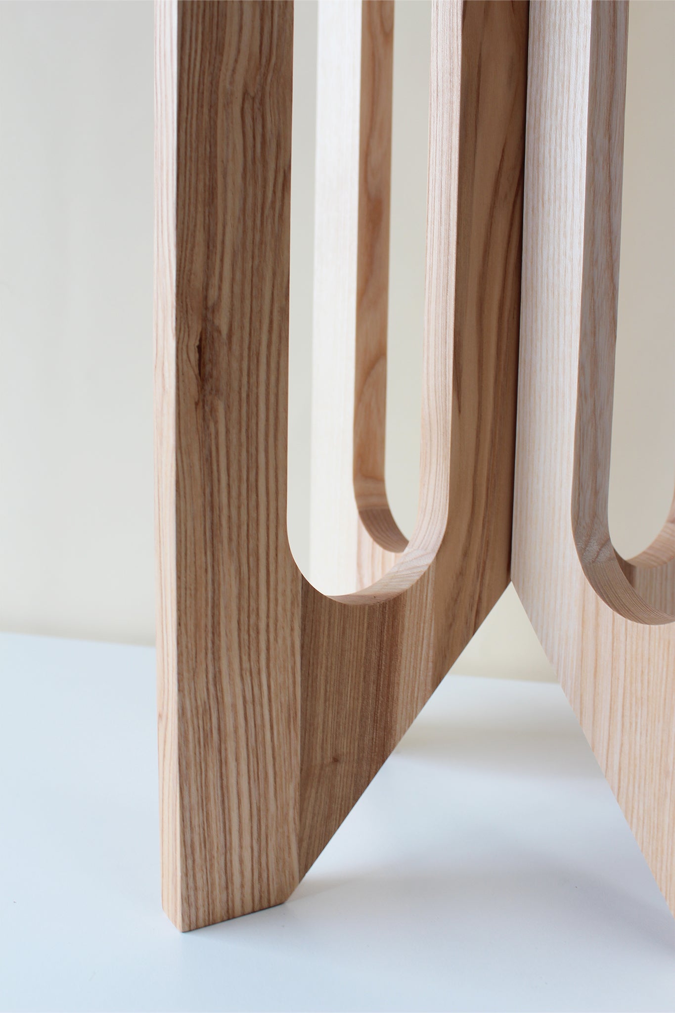 close up of base of arches wooden plant stand by braid & wood