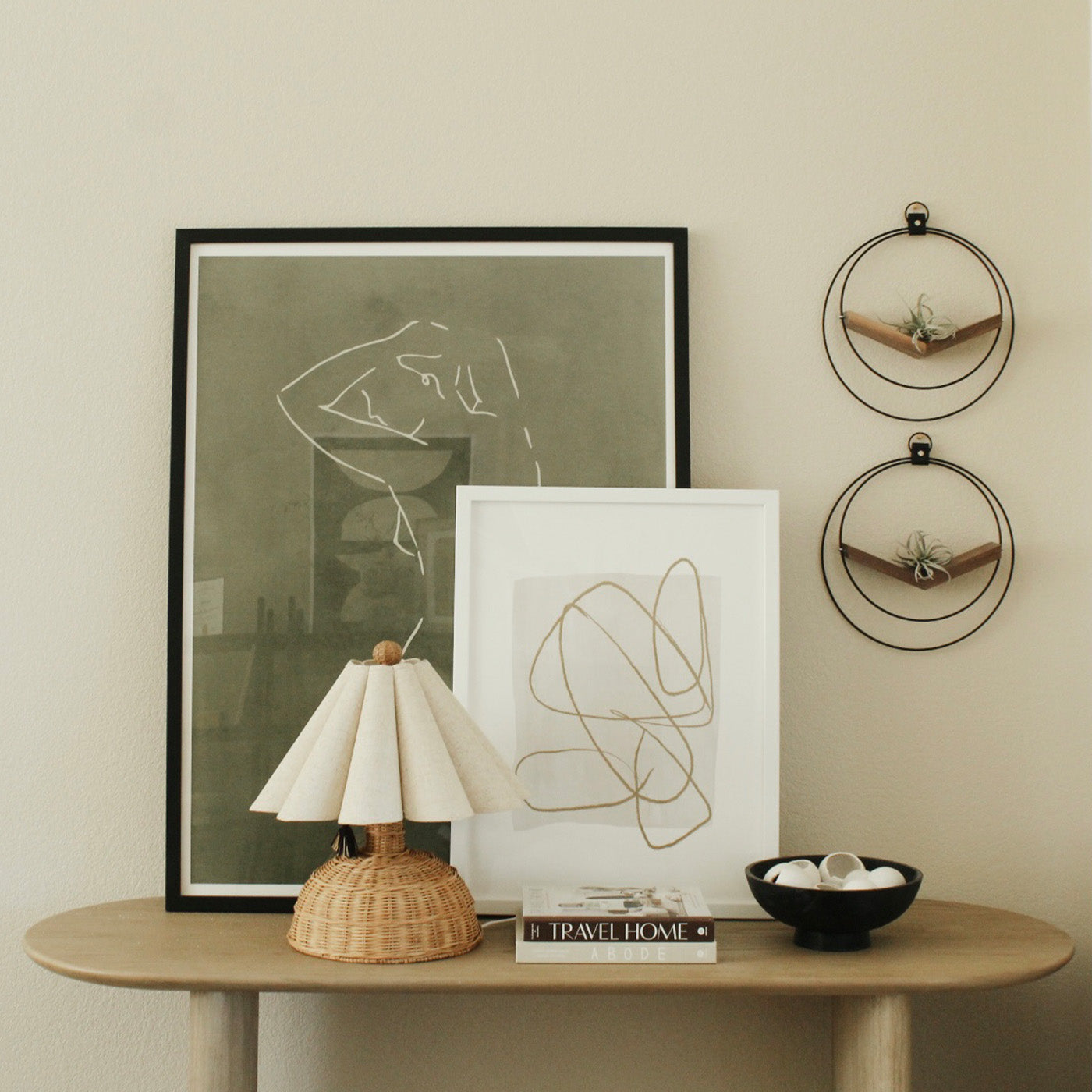 two modern black and walnut plant shelves by braid & wood styled above modern console table