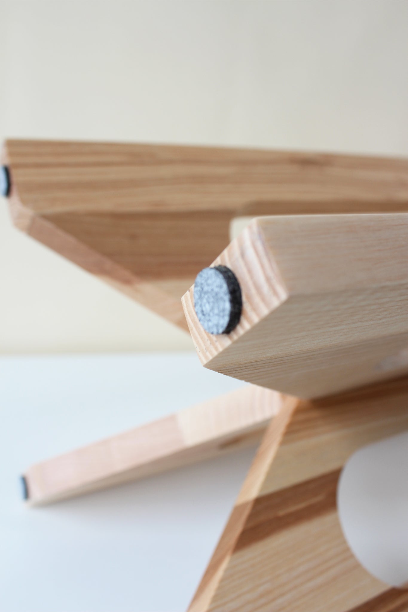 felt pads on the bottom feet of the arches wood plant stand by braid & wood