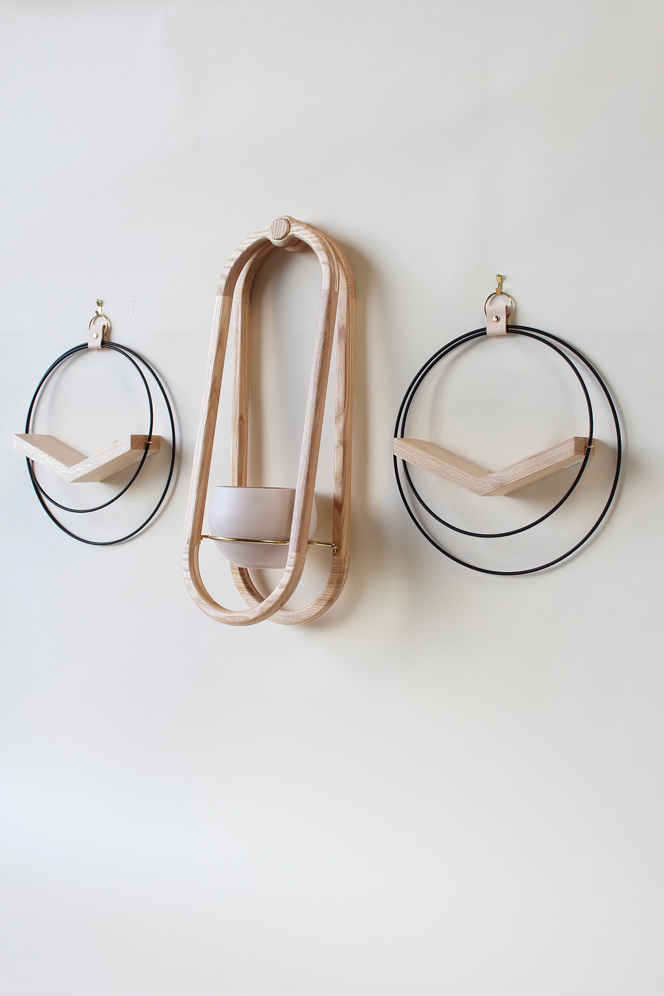 three modern wall mounted plant shelves on white background