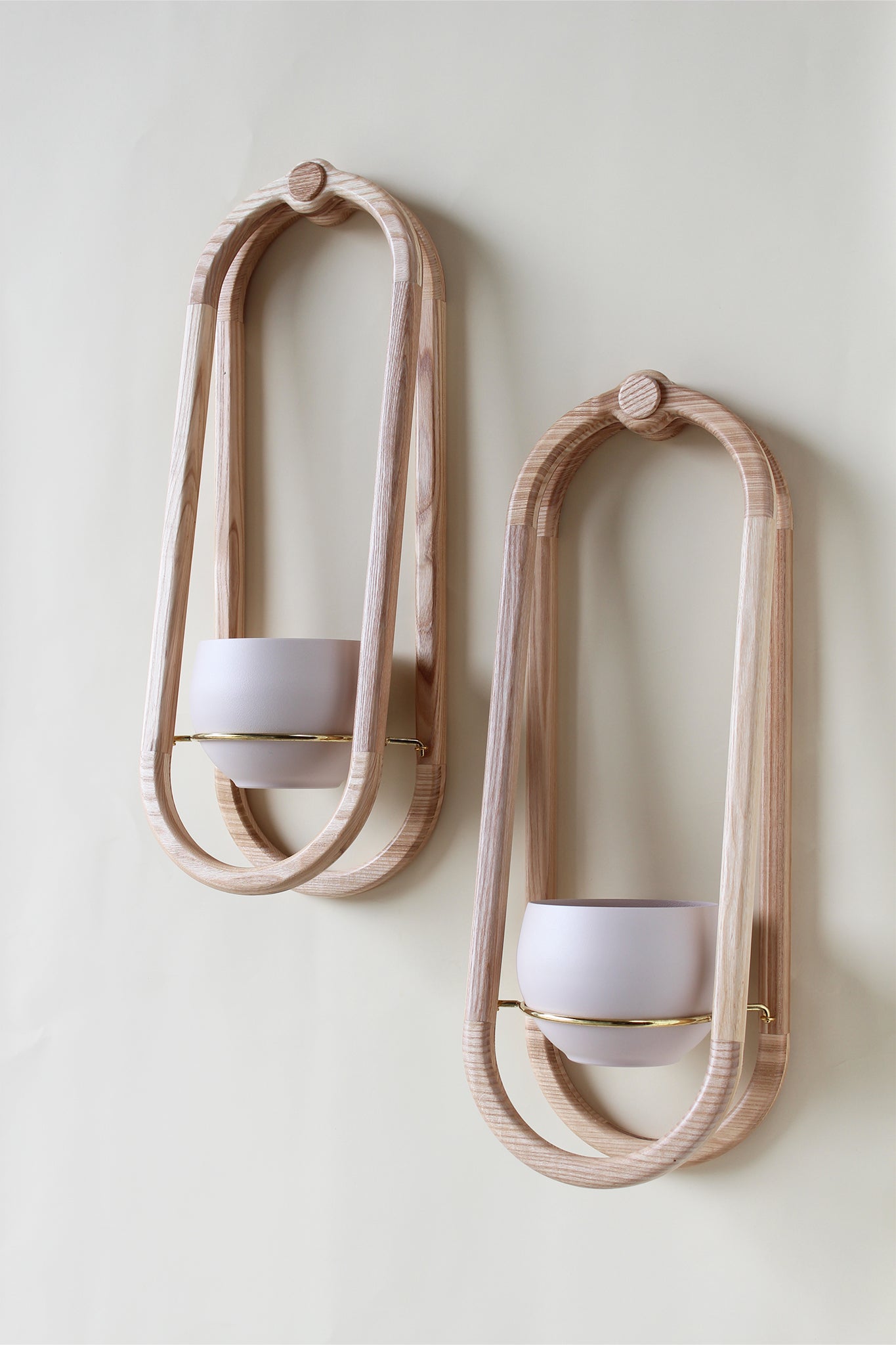 modern obround wall mounted wood planter with blush colored aluminum pots