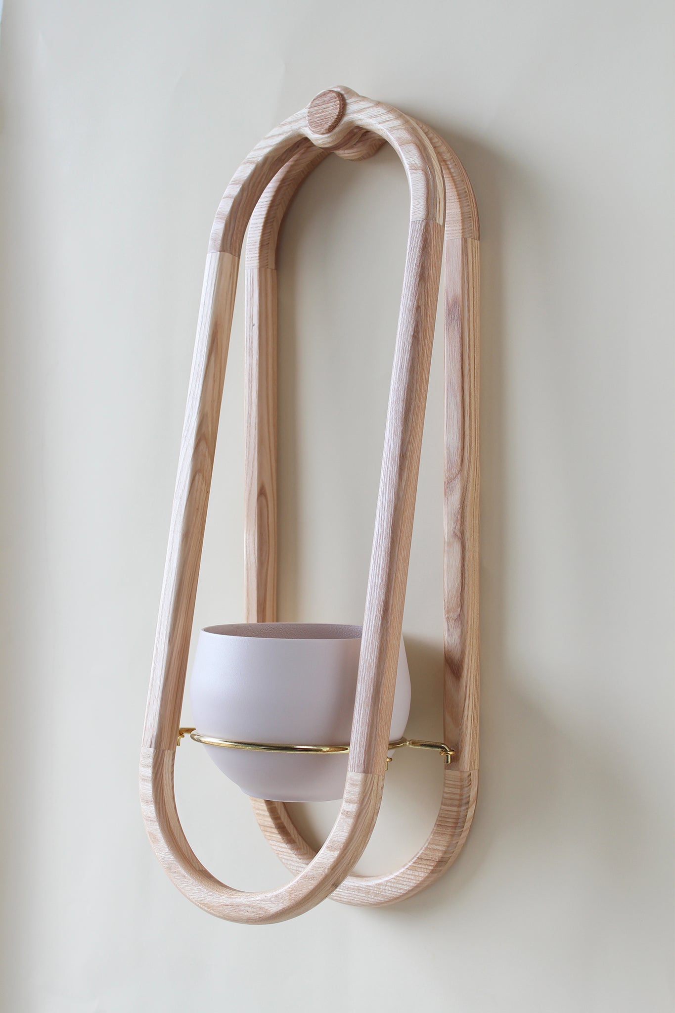 modern scandi inspired obround wall mounted planter with blush colored pot