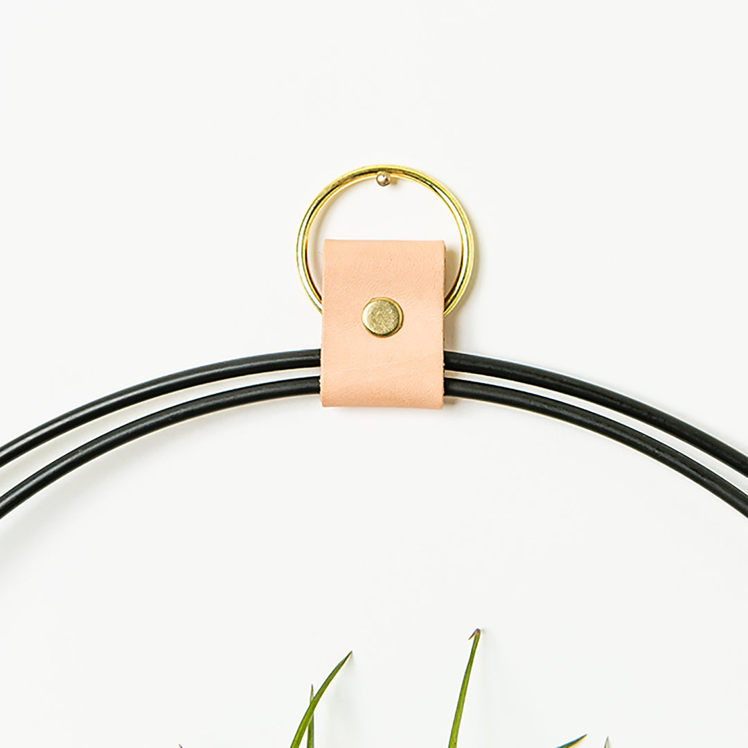 detailed view of blush colored leather strap detail for black and gold large v air plant holder