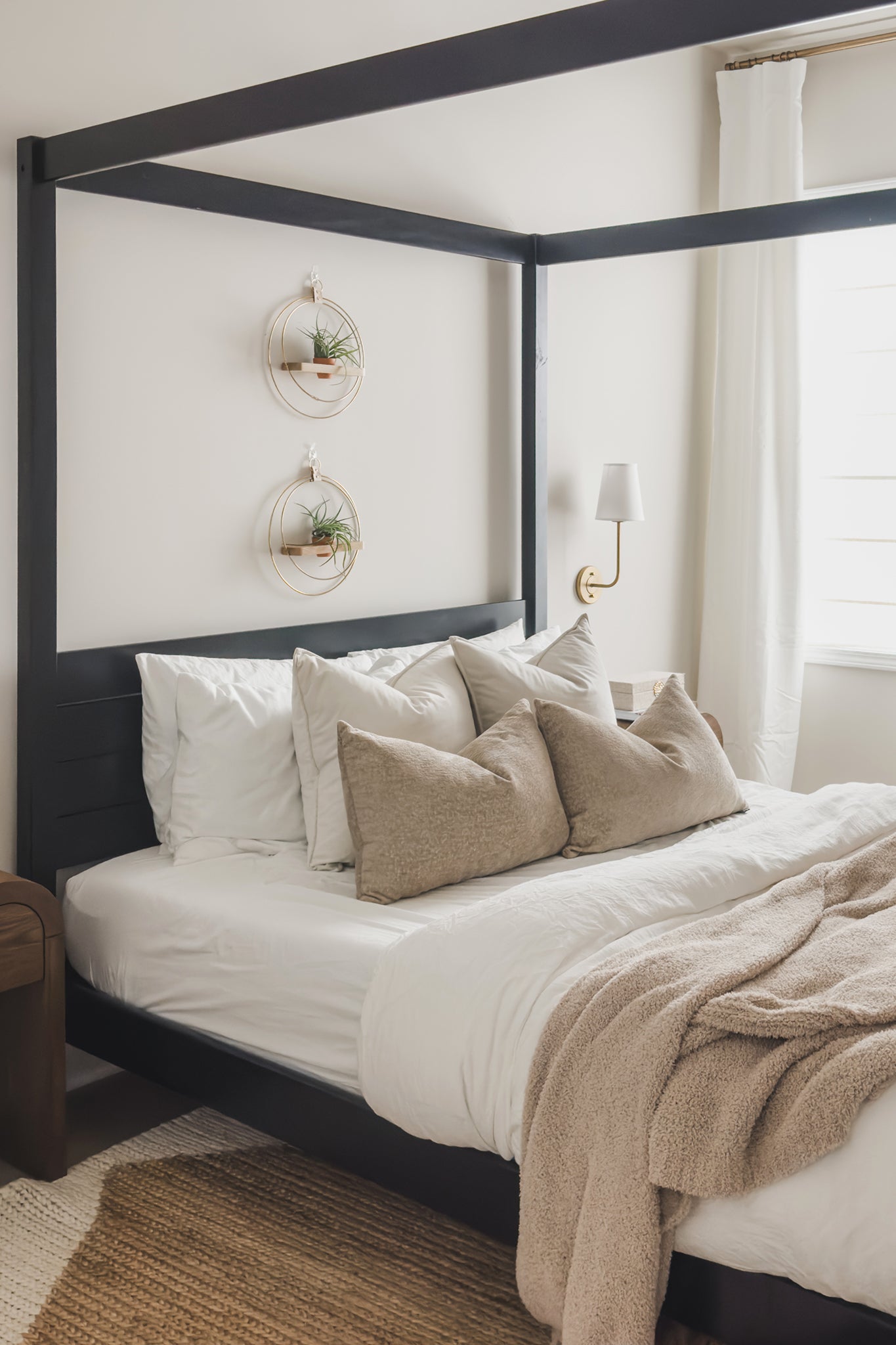two vertically placed modern plant shelves above a canopy bed