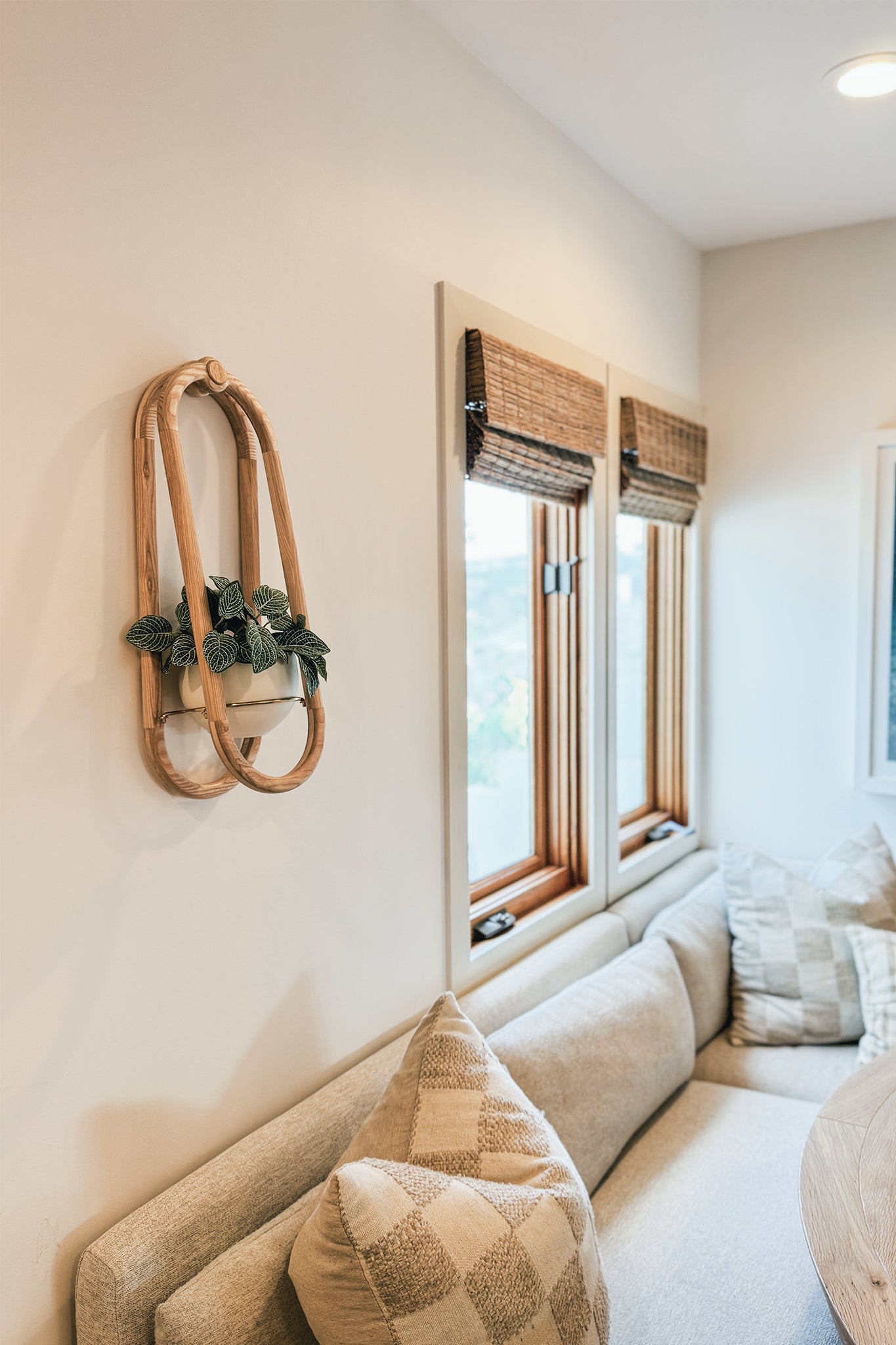 The Frame Wall Plant and spun aluminum pot on a wall in a modern breakfast nook.