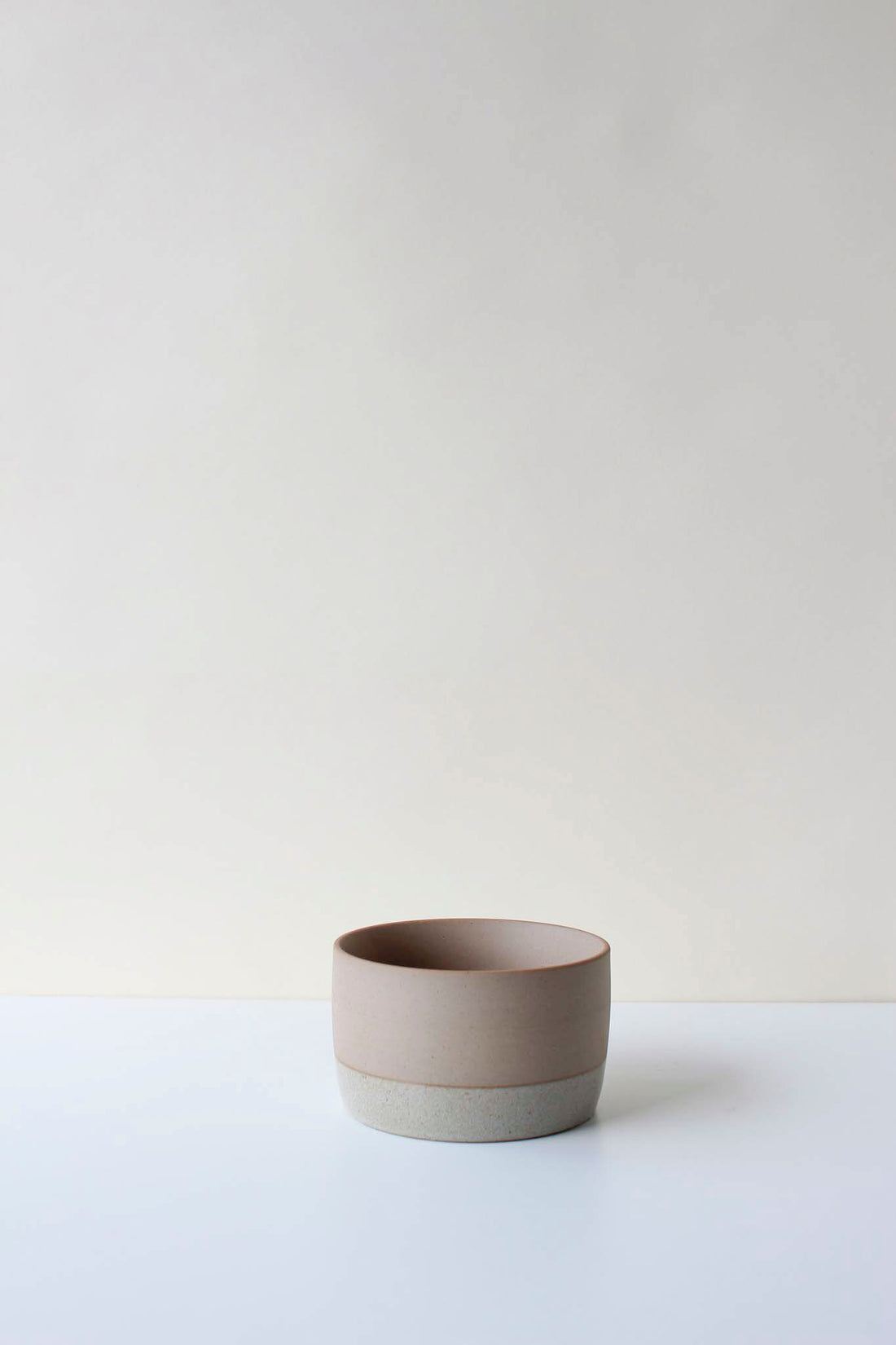 Ceramic air plant soaking dish on a white surface with a plain background