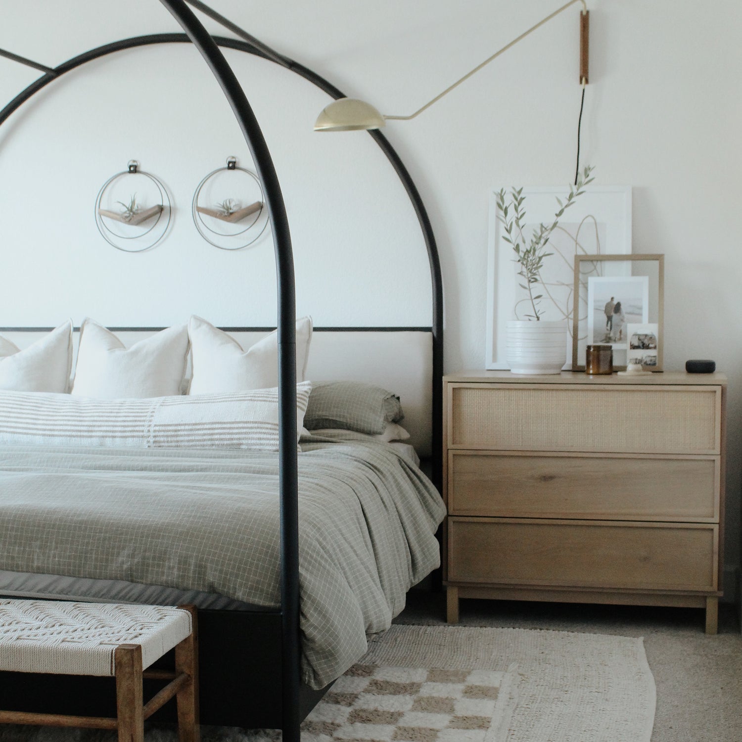 black v shaped air plant hangers styled in a bedroom