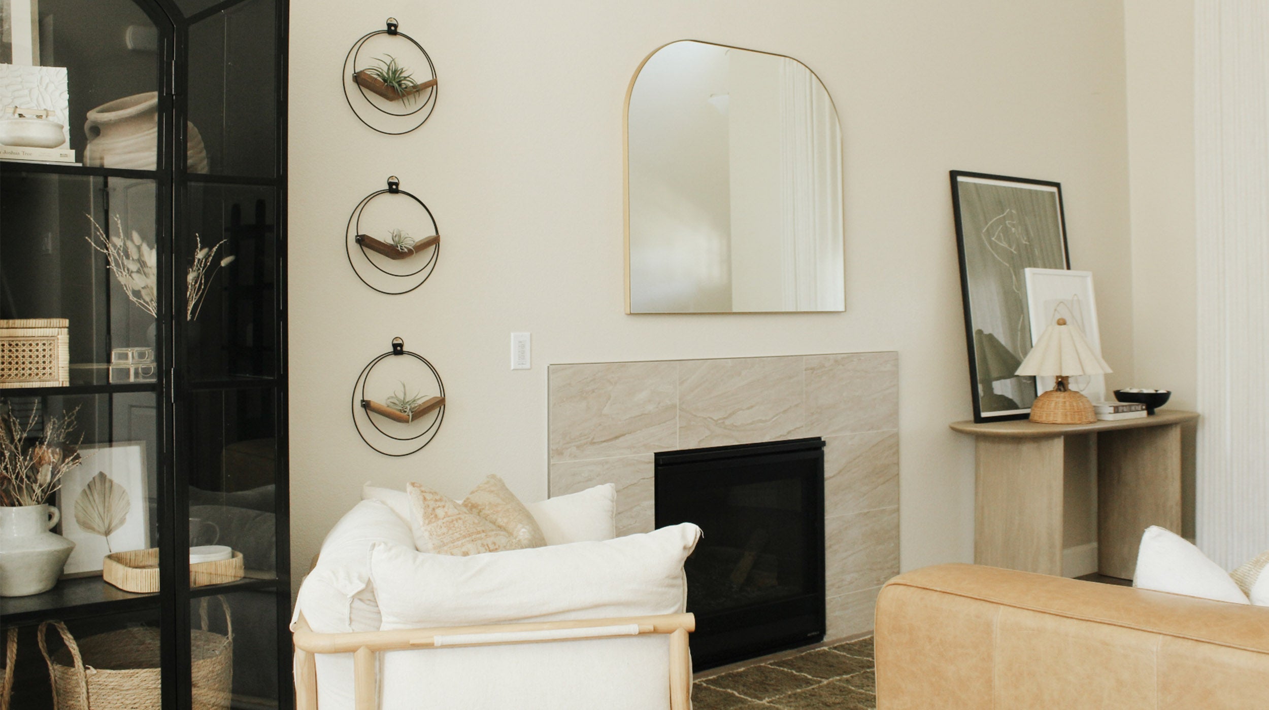 three modern black and walnut plant shelves by braid & wood styled in neutral living room