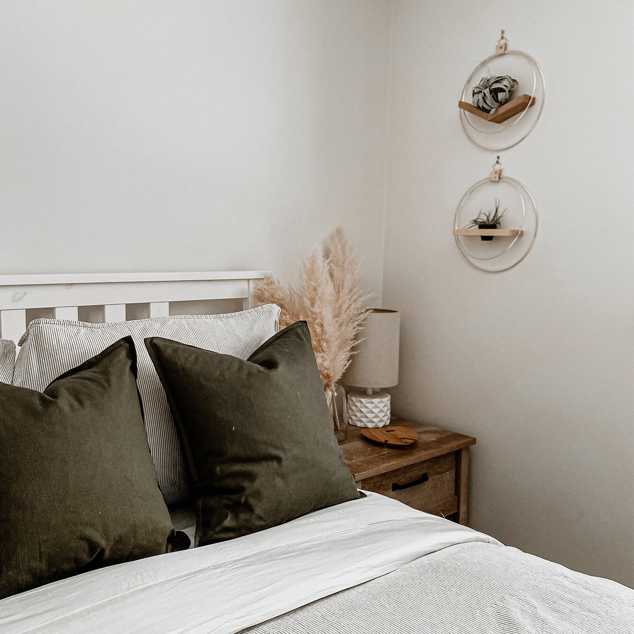 v shaped air plant holder and wall shelf styled in a modern bedroom