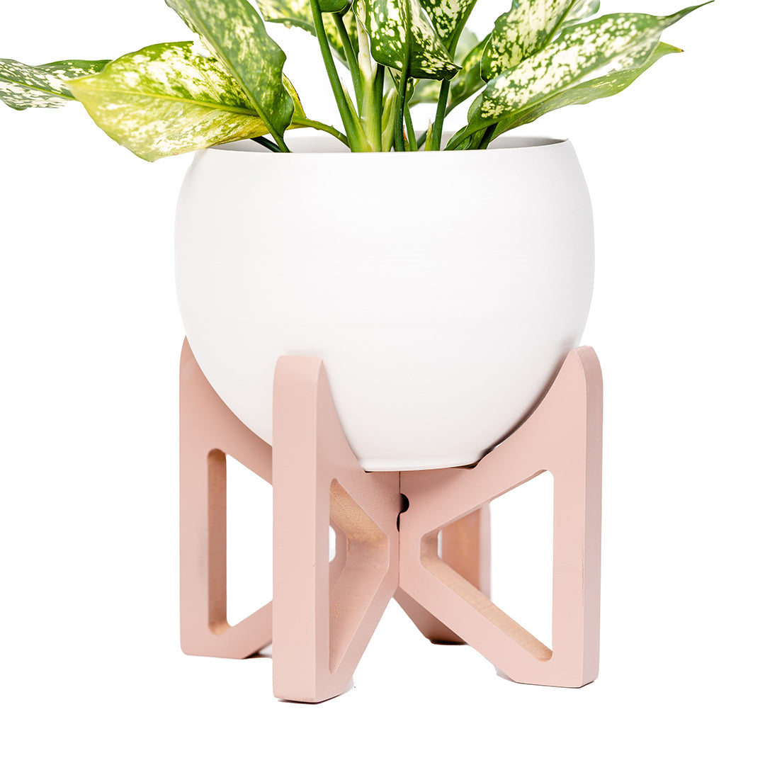 dark blush wood plant stand with white aluminum pot and houseplant