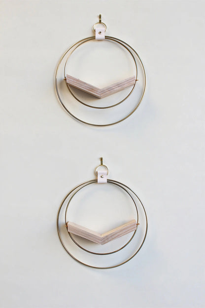 two small gold circular modern wall mounted air plant holders with light white ash hardwood on white background