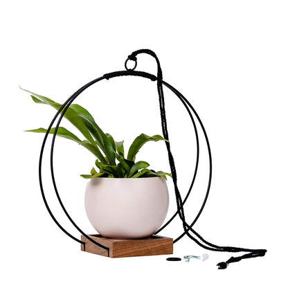 large plant hanger with black metal and walnut wood base and blush colored aluminum pot