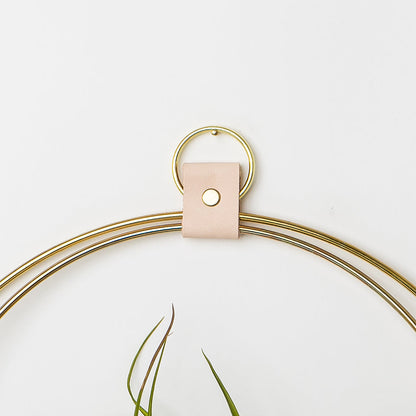 leather strap detail of large air plant hanger with gold metal and white oak wood base