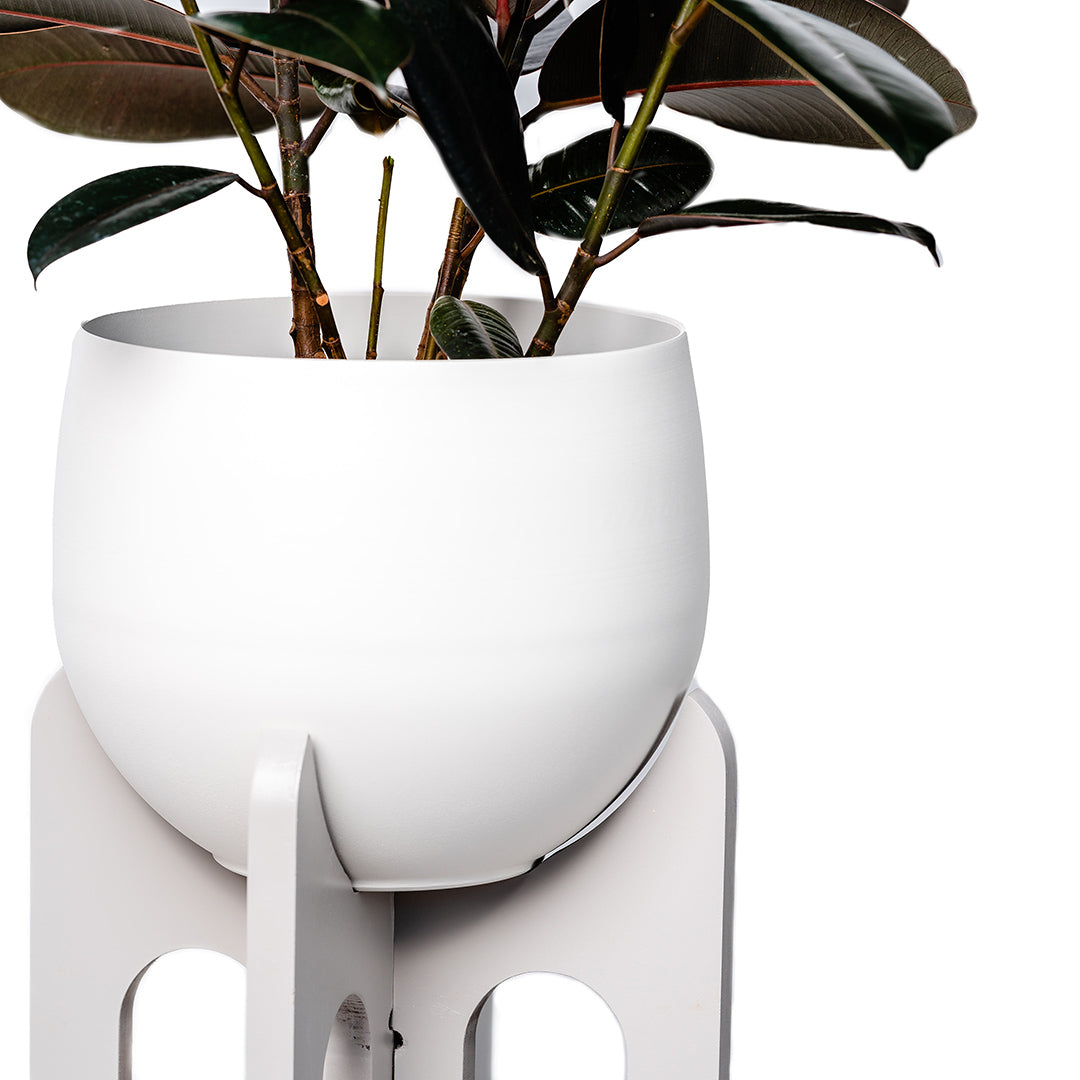 close up view of top of gray floor plant stand with white aluminum pot and plant